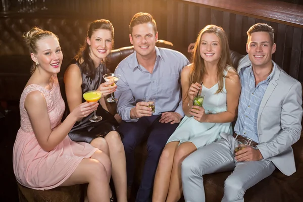 Friends holding glasses of cocktail in bar — Stock Photo, Image