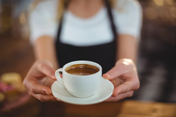 Waitress offering cup of coffee — Stock Photo, Image