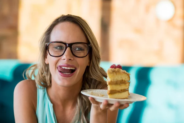 Woman holding pastries on plate — Stock Photo, Image