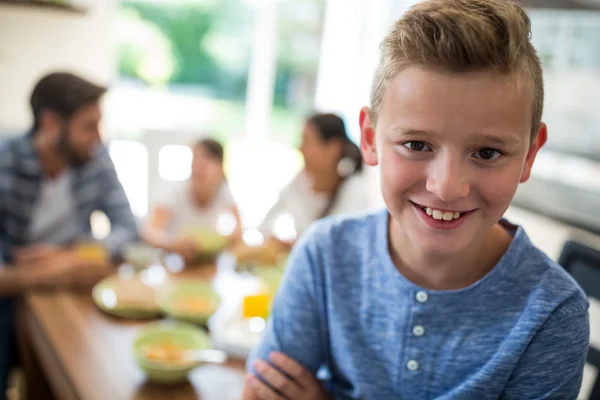 Portrait of boy sitting on dining table — ストック写真