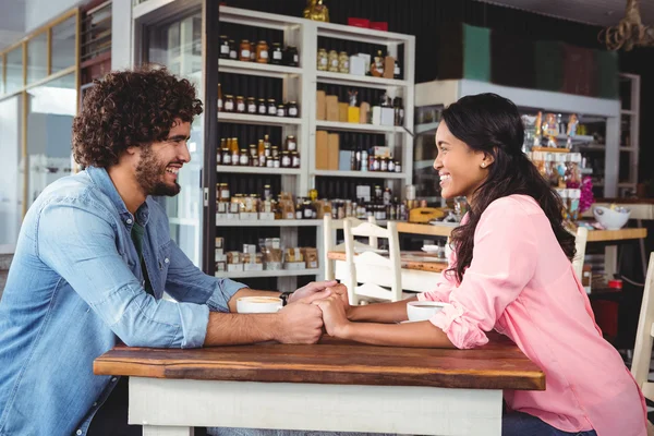 Couple holding hands and smiling — Stock Photo, Image