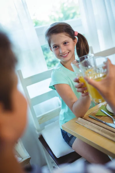 Menina brindar copo de suco de laranja — Fotografia de Stock