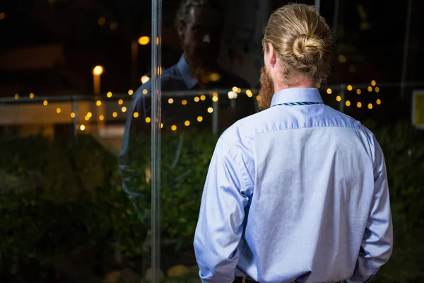 Businessman looking out of window — Stock Photo, Image