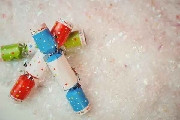 Christmas crackers on snow — Stock Photo, Image