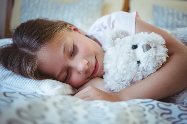 Girl lying with a teddy bear — Stock fotografie