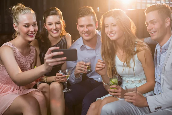 Smiling friends taking selfie from phone — Stock Photo, Image