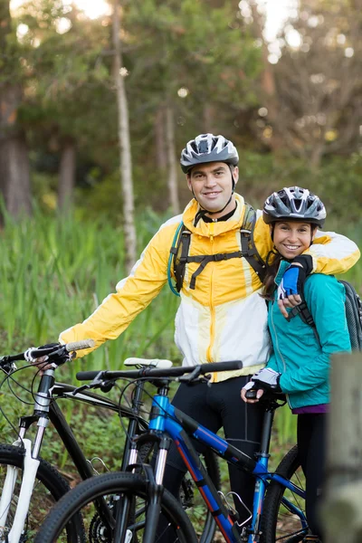 Biker couple with mountain bike in countryside — Stock Photo, Image