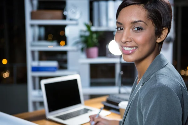 Businesswoman in office at night — Stock Photo, Image