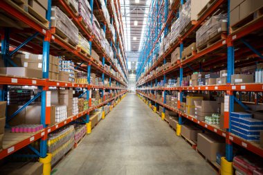 Boxes kept on shelves in warehouse clipart