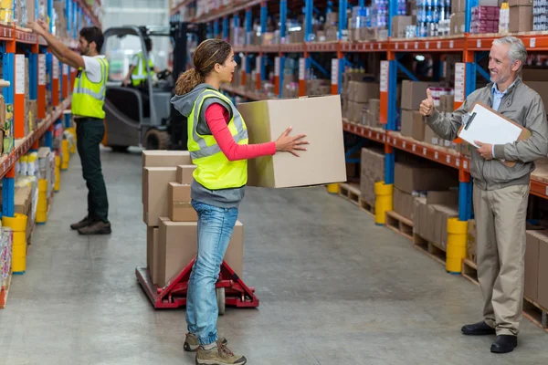 Warehouse manager showing thumb up to worker — Stock Photo, Image