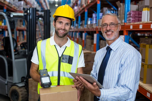 Warehouse manager holding tablet — Stock Photo, Image