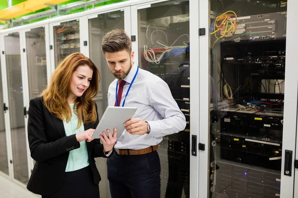 Technicians using digital tablet while analyzing server — Stock Photo, Image