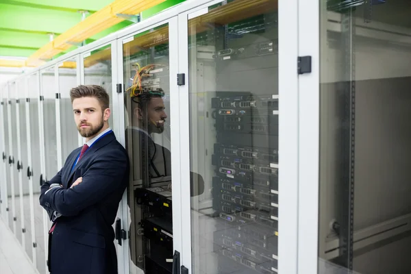Technician standing with arms crossed in a server room — Φωτογραφία Αρχείου