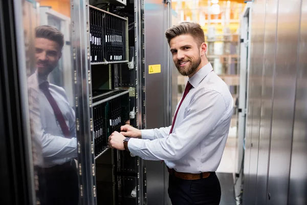 Technician examining server — ストック写真