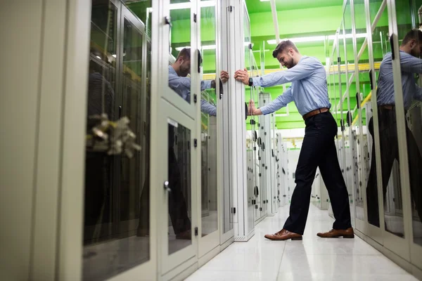 Technician adjusting server cabinet — ストック写真