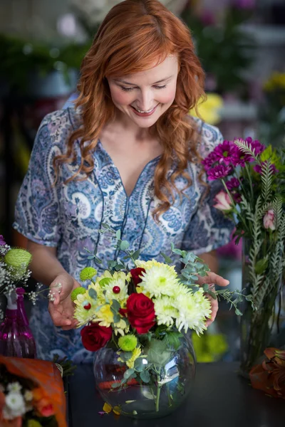 Florist checking flowers arrangement in vase — Stock Photo, Image