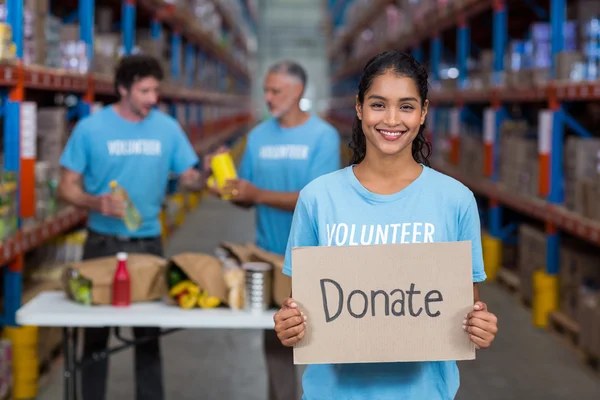 Volunteer holding sign board with message — Stock Photo, Image