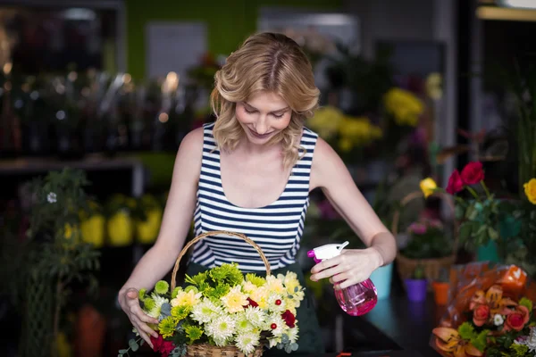 Florists spraying water on flowers — Stock Photo, Image