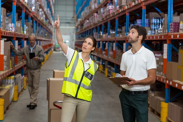 Male and female workers checking inventory — Stock Photo, Image