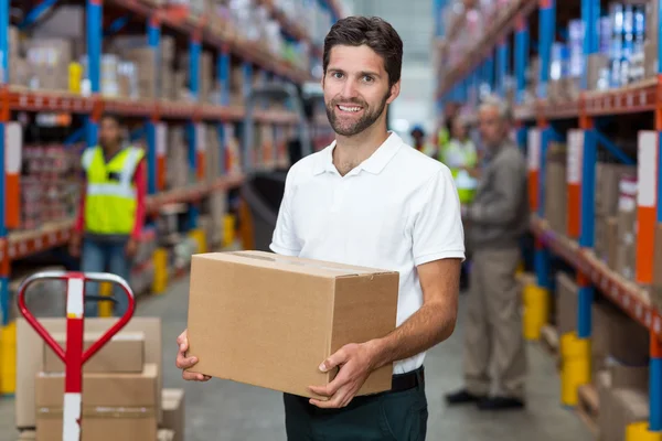 Male worker holding cardboard box — Stock Photo, Image