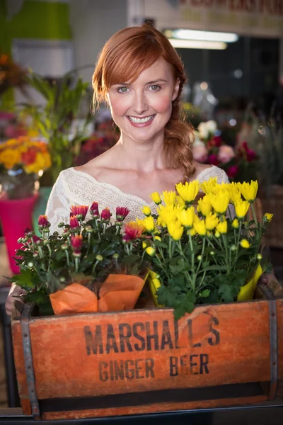 Florist holding crate of flower bouquet — Stock Photo, Image