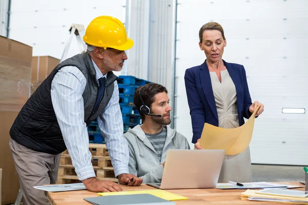 Warehouse workers and managers interacting — Stock Photo, Image