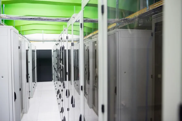 Hallway with row of servers — ストック写真