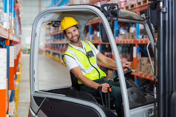 Male worker using forklift — Stock Photo, Image