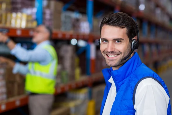 Warehouse worker in headset — Stock Photo, Image