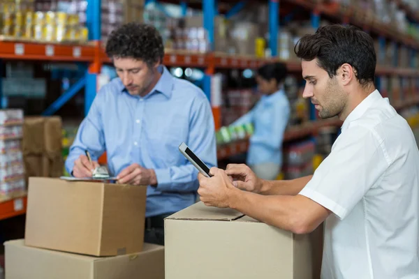 Due magazzinieri che lavorano insieme — Foto Stock