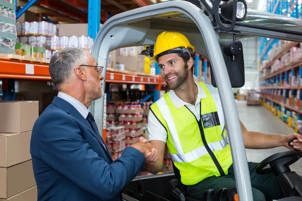 Warehouse worker shaking hands manager — Stock Photo, Image