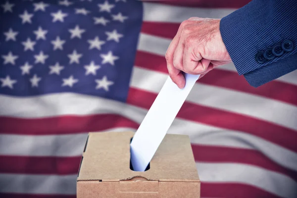 Businessman putting ballot in vote box — Stock Photo, Image