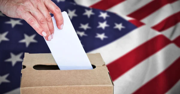 Businesswoman putting ballot in vote box — Stock Photo, Image