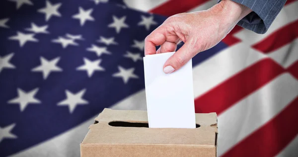 Businesswoman putting ballot in vote box — Stock Photo, Image