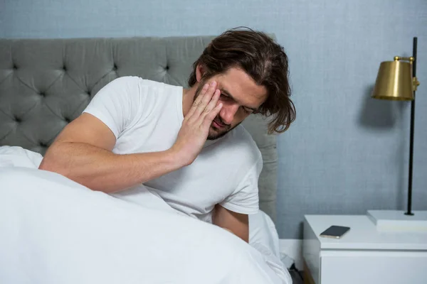 Man waking up from sleep in bedroom — Stock Photo, Image