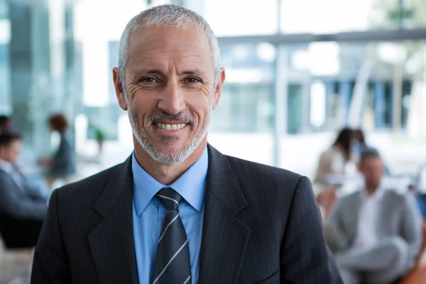 Smiling businessman in office — Stock Photo, Image