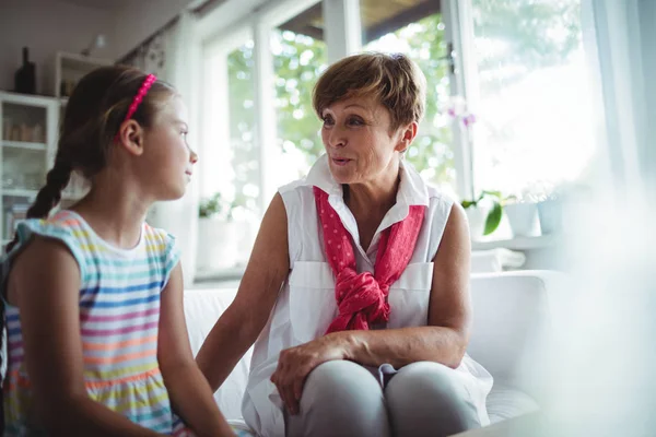 Senior woman and her granddaughter interacting with each other — Stock Photo, Image
