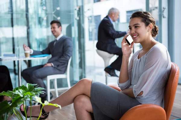 Podnikatelka mluví na mobilním telefonu v kanceláři — Stock fotografie