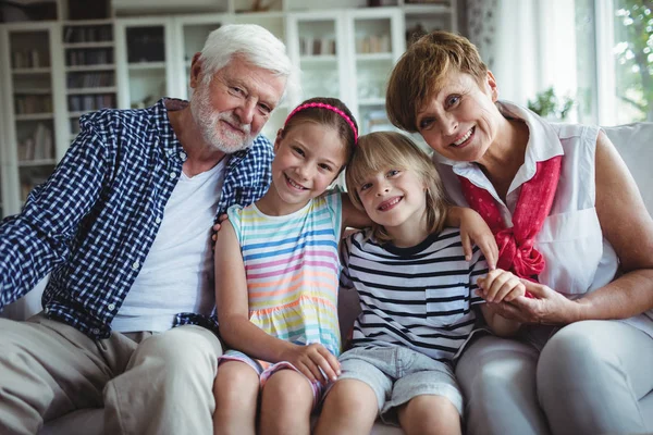 Portrait of grandparents sitting with their grandchildren — Stock Photo, Image