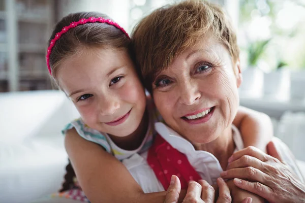 Portrait of granddaughter embracing her grandmother — Stock Photo, Image