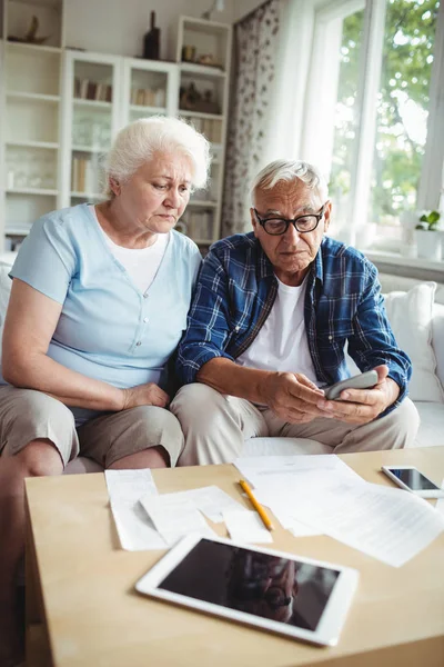 Worried senior couple checking bills — Stock Photo, Image