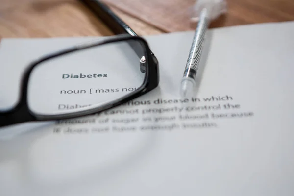 Injection with diabetes test paper and spectacle — Stock Photo, Image