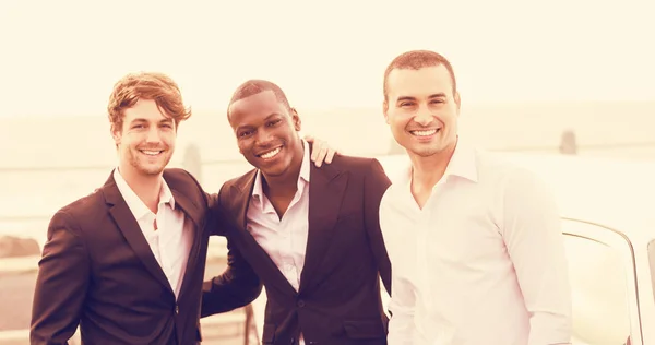 Men posing next to limousine — Stock Photo, Image