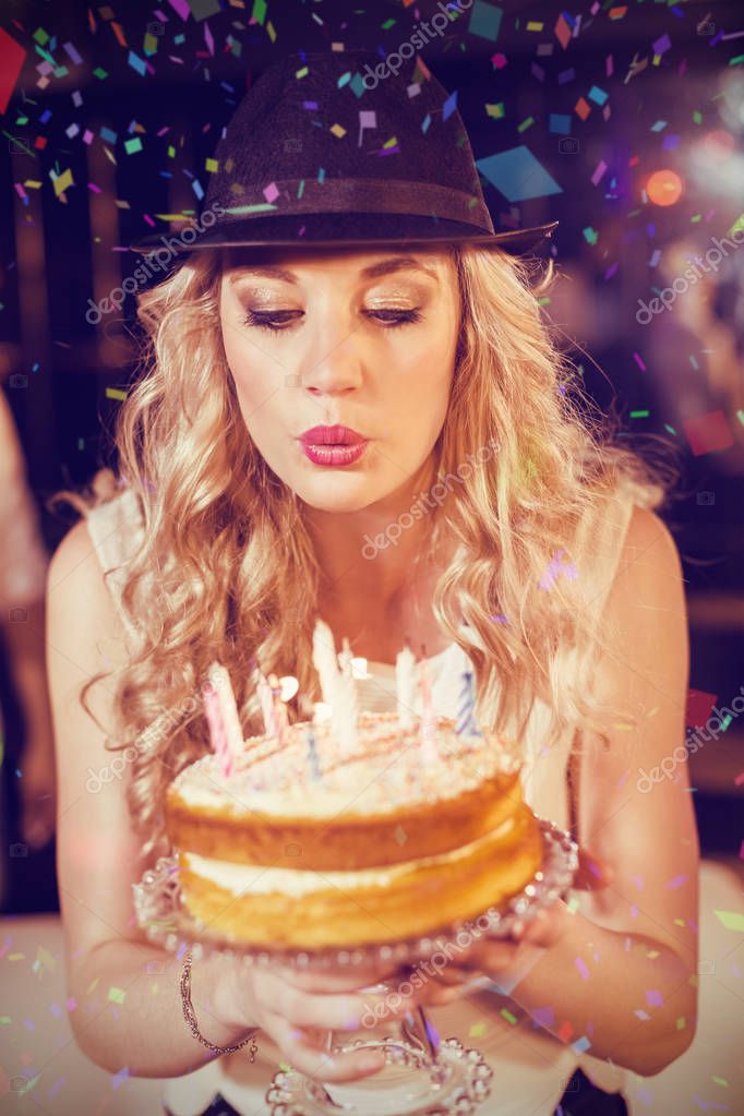 Woman blowing out candles — Stock Photo © Wavebreakmedia 130054690