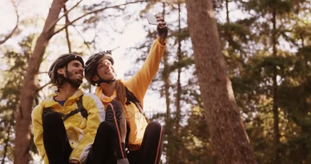 Mountain biking couple taking selfie — Stock Video