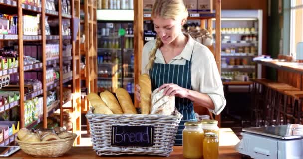 Smiling female staff at bread counter — Stock Video