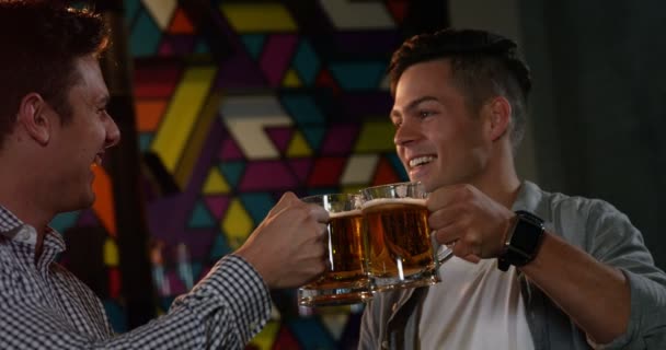 Vrienden roosteren glazen bieren — Stockvideo