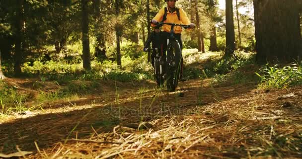 Mountain biking couple riding in forest — Stock Video