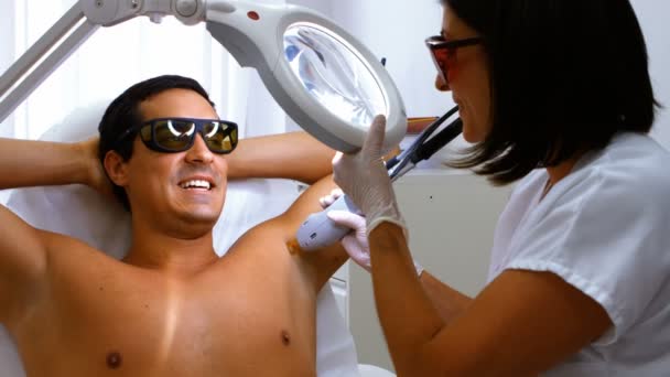 Doctor performing laser hair removal — Stock Video