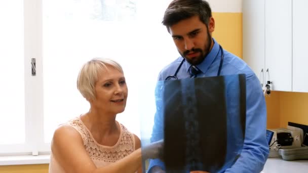 Doctor discussing x-ray with patient — Stock Video